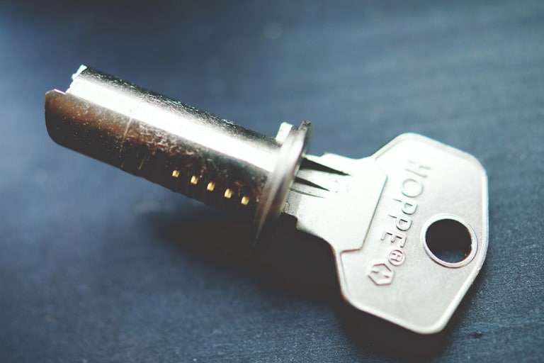 Locksmith cost - silver key on blue background