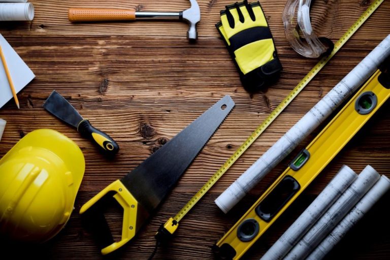 Tools and Hard-hat on Wooden Floor