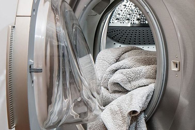 Washing Machine with towel falling out of opening